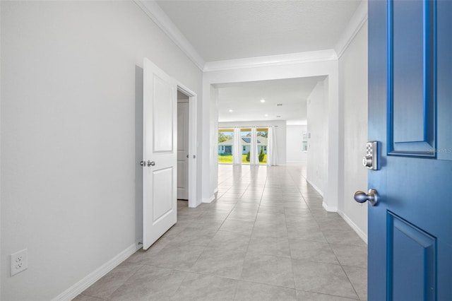 interior space with a textured ceiling, light tile patterned flooring, and ornamental molding