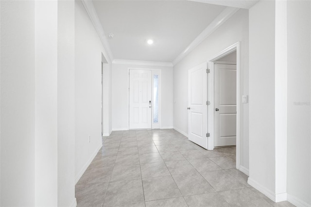 hallway featuring light tile patterned floors and crown molding