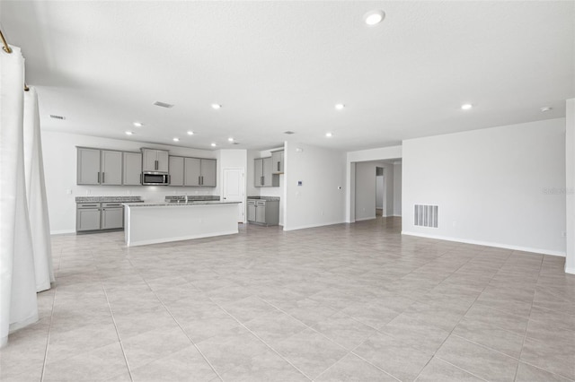 unfurnished living room with light tile patterned flooring