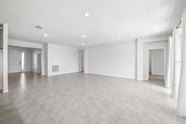 unfurnished living room with a textured ceiling