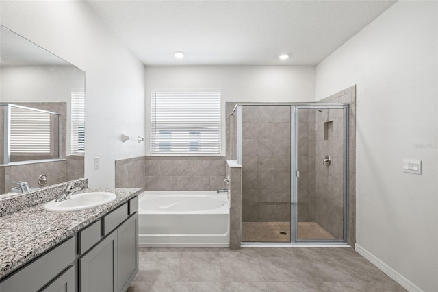 bathroom featuring vanity, tile patterned floors, a healthy amount of sunlight, and separate shower and tub