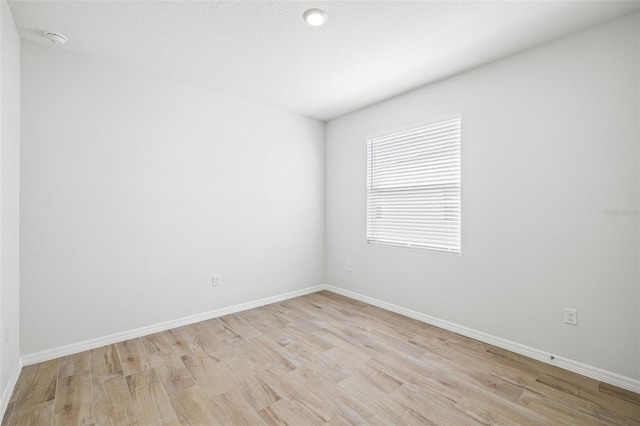 spare room with light hardwood / wood-style floors