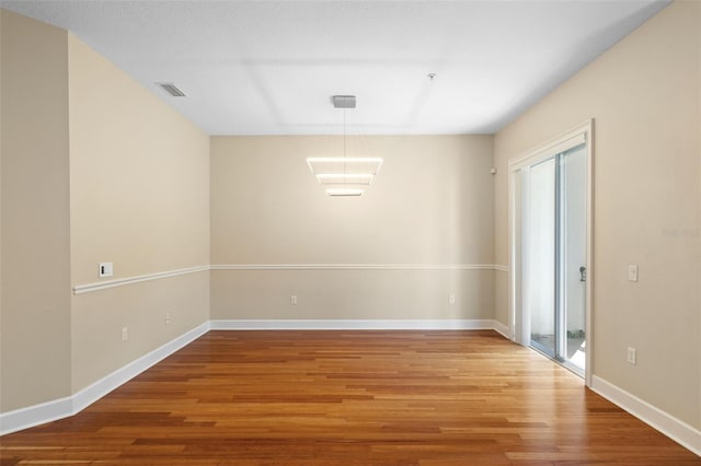 empty room featuring wood-type flooring and a wealth of natural light