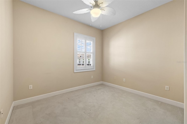 empty room with ceiling fan and light carpet