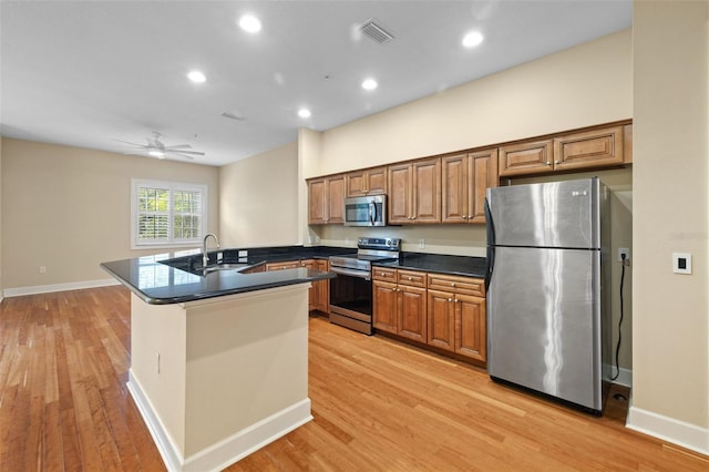 kitchen with ceiling fan, sink, light hardwood / wood-style flooring, and appliances with stainless steel finishes