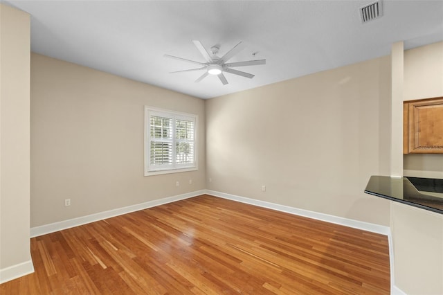 interior space with wood-type flooring and ceiling fan