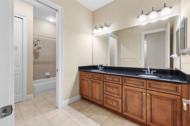 bathroom with tile patterned flooring, vanity, and tiled shower / bath