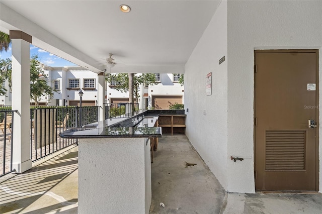 view of patio featuring an outdoor bar and ceiling fan