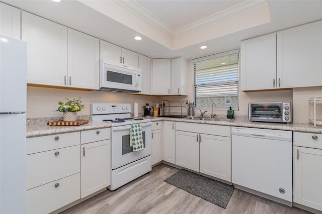 kitchen featuring light hardwood / wood-style floors, sink, white cabinetry, white appliances, and crown molding