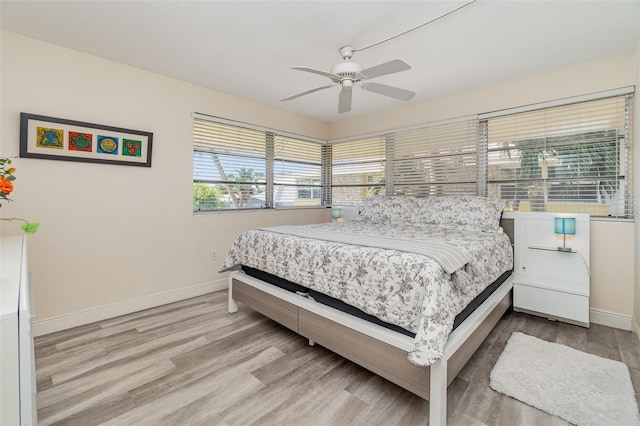 bedroom with light hardwood / wood-style floors and ceiling fan