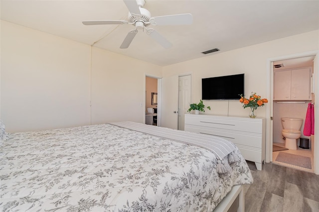 bedroom featuring ceiling fan, light hardwood / wood-style flooring, and ensuite bath