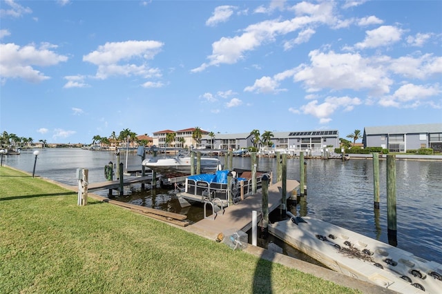 dock area with a water view and a yard