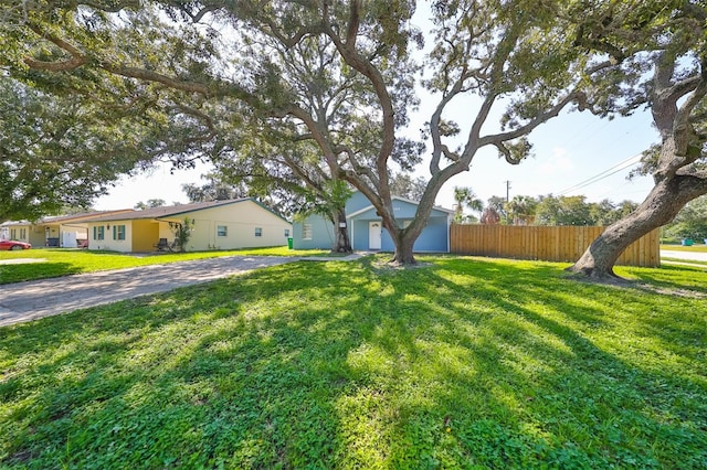 view of front of property with a front lawn and a garage