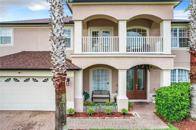 view of front of house with a balcony and a garage