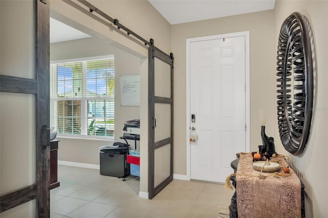 tiled entrance foyer featuring a barn door