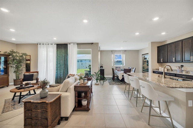 tiled living room featuring sink