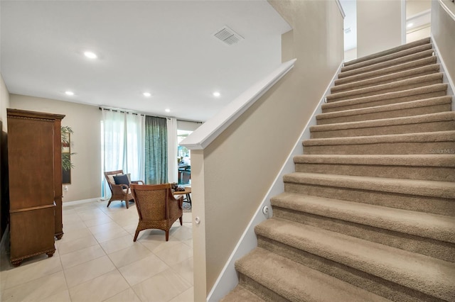 stairs featuring tile patterned floors