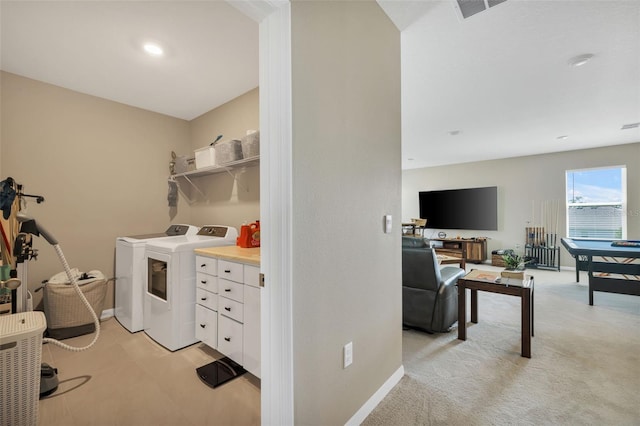 laundry area with light colored carpet and washing machine and dryer