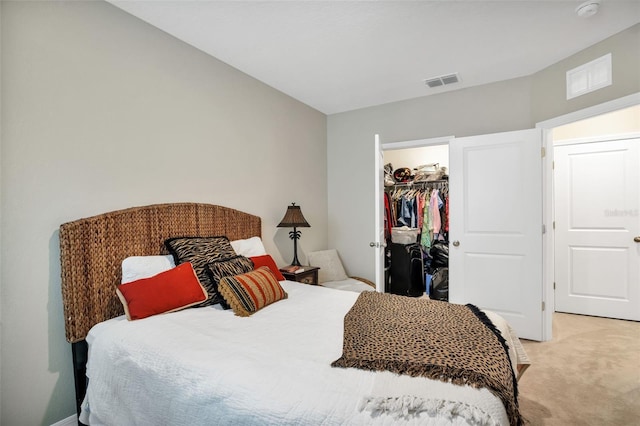 carpeted bedroom with a closet and a spacious closet