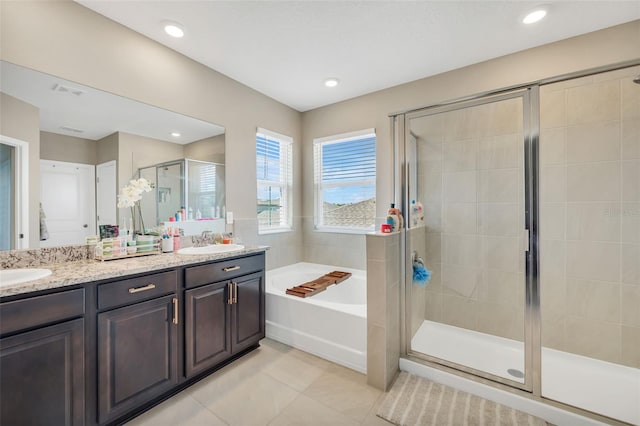 bathroom featuring vanity, plus walk in shower, and tile patterned floors