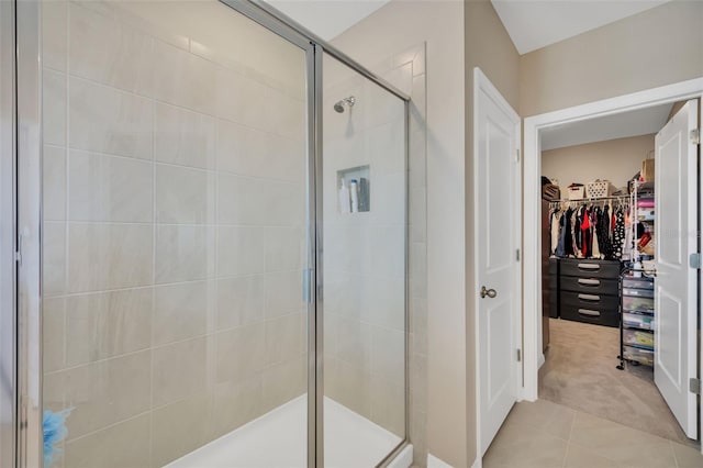 bathroom with tile patterned flooring and a shower with door