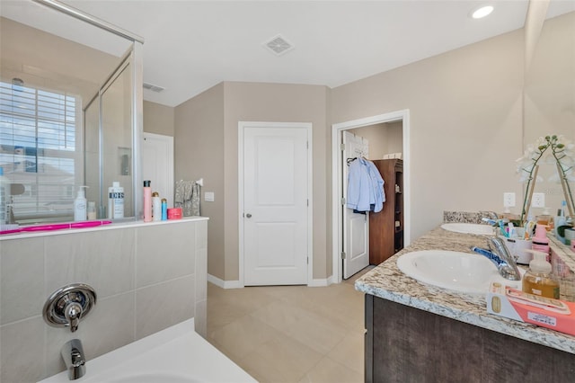 bathroom featuring a shower with door and vanity