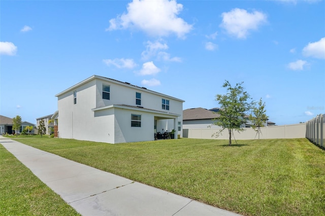 rear view of property featuring a yard