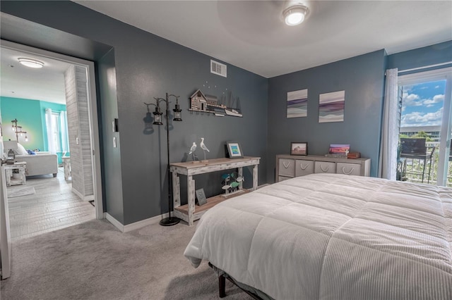 carpeted bedroom featuring ceiling fan and access to exterior