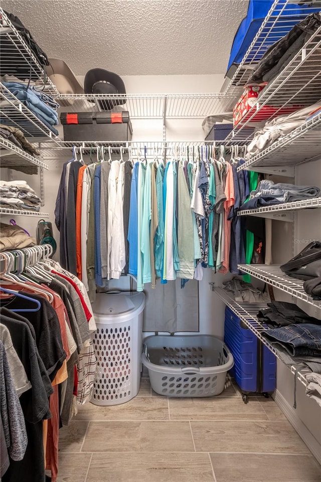 walk in closet with hardwood / wood-style flooring