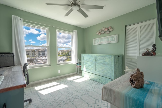 bedroom featuring ceiling fan, light colored carpet, and a closet