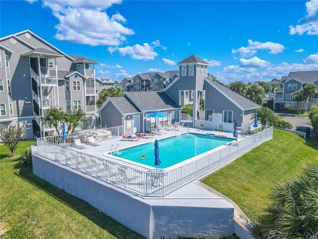 view of swimming pool featuring a lawn and a patio