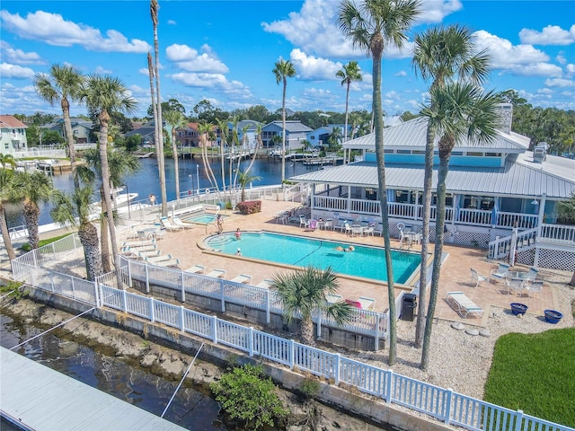 view of pool featuring a patio and a water view