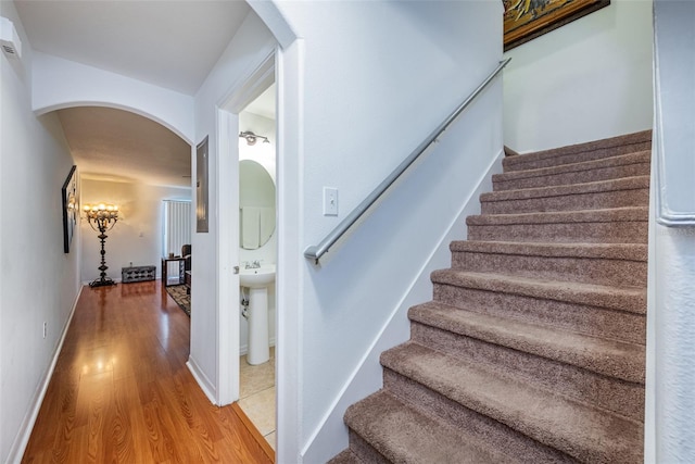 staircase featuring wood-type flooring