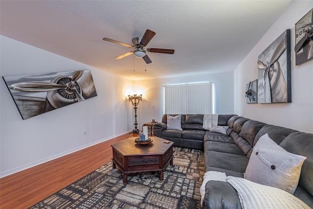 living room with ceiling fan, a textured ceiling, and hardwood / wood-style floors