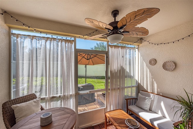 sunroom / solarium featuring ceiling fan