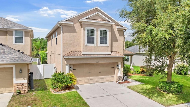 view of front facade featuring a garage and a front lawn