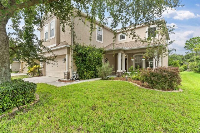 view of front facade with a garage and a front yard