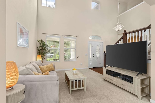 living room with a high ceiling and carpet