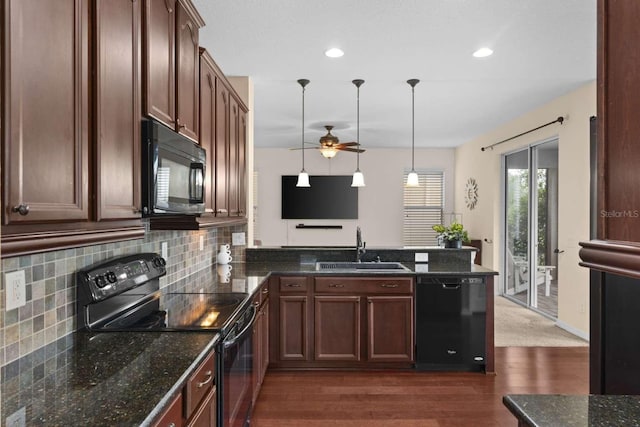 kitchen featuring dark hardwood / wood-style flooring, black appliances, ceiling fan, decorative light fixtures, and sink