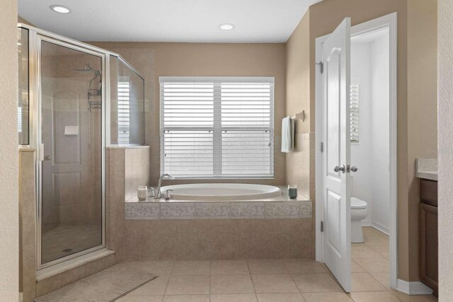 full bathroom featuring plus walk in shower, tile patterned floors, vanity, and toilet