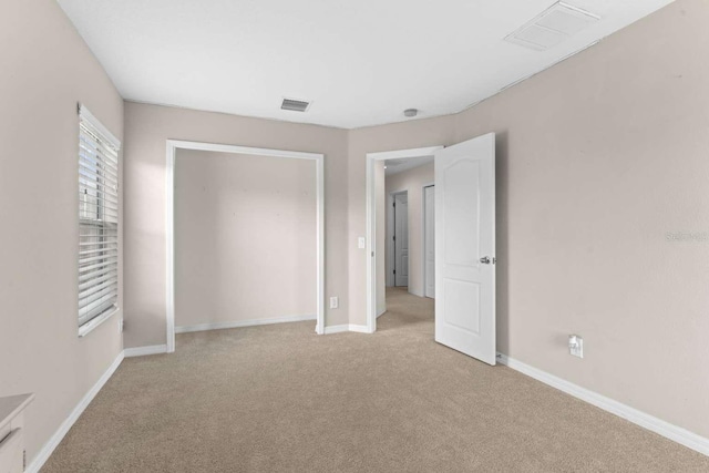 unfurnished bedroom featuring light colored carpet