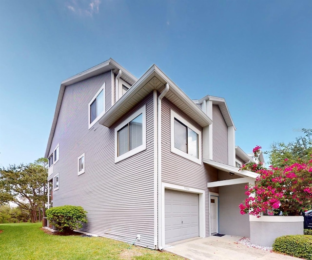 view of home's exterior with a lawn and a garage