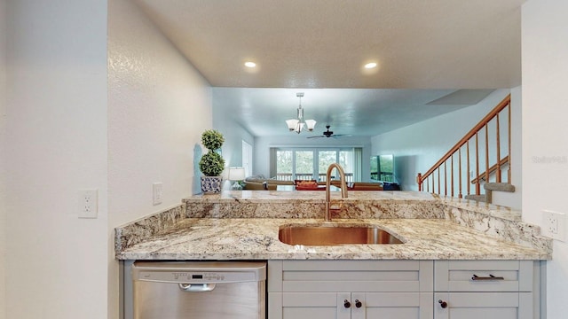 kitchen featuring sink, a textured ceiling, dishwasher, an inviting chandelier, and light stone countertops