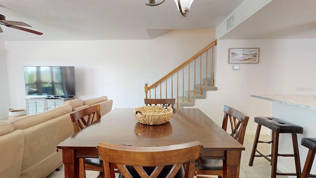 carpeted dining area featuring ceiling fan