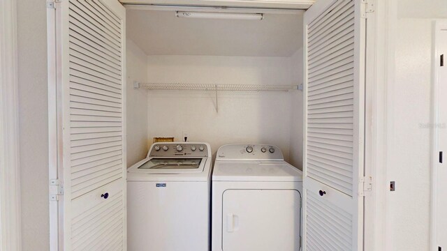 clothes washing area featuring washing machine and dryer