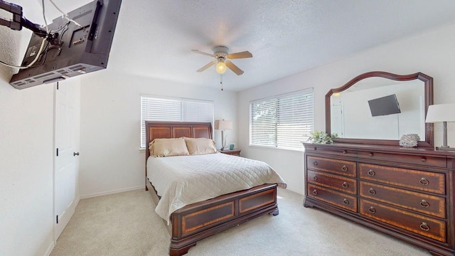 carpeted bedroom featuring a textured ceiling and ceiling fan