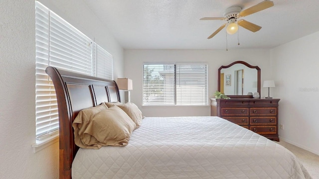 bedroom with ceiling fan and carpet flooring