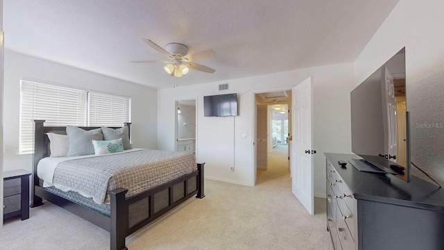 carpeted bedroom with ceiling fan, a textured ceiling, and connected bathroom