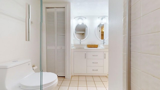 bathroom featuring tile patterned flooring, vanity, and toilet