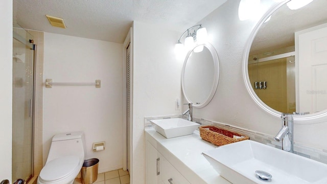 bathroom with vanity, toilet, and a shower with shower door